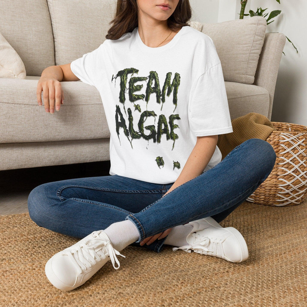 Woman wearing white 'Team Algae' graphic tee with green dripping text, casual protest apparel