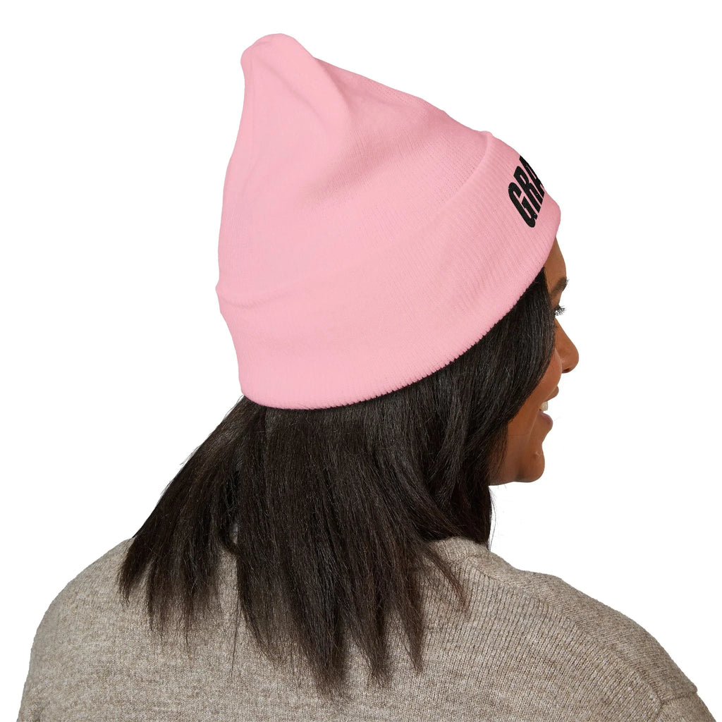 Woman wearing pink protest beanie with bold lettering, political statement merch