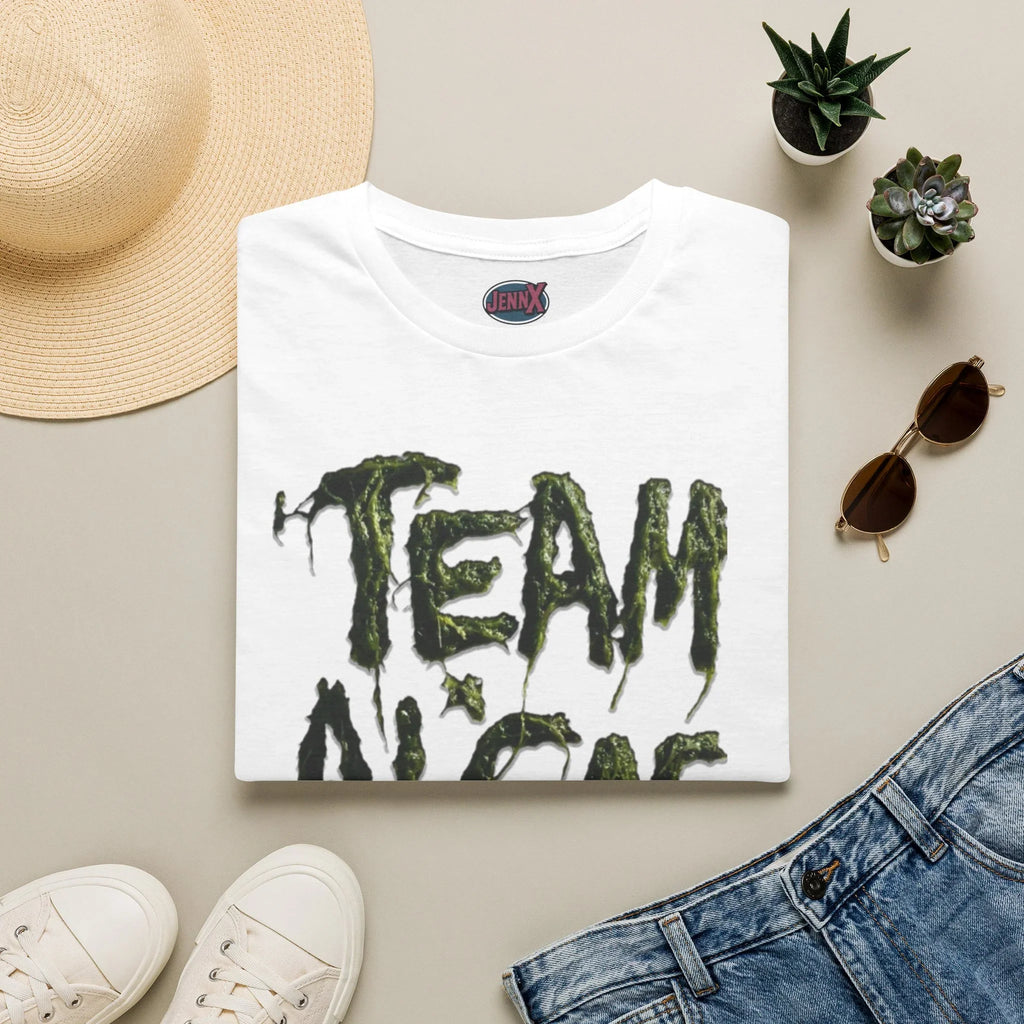 White protest tee with 'TEAM' in green, dripping font, styled with hat, jeans, and succulents