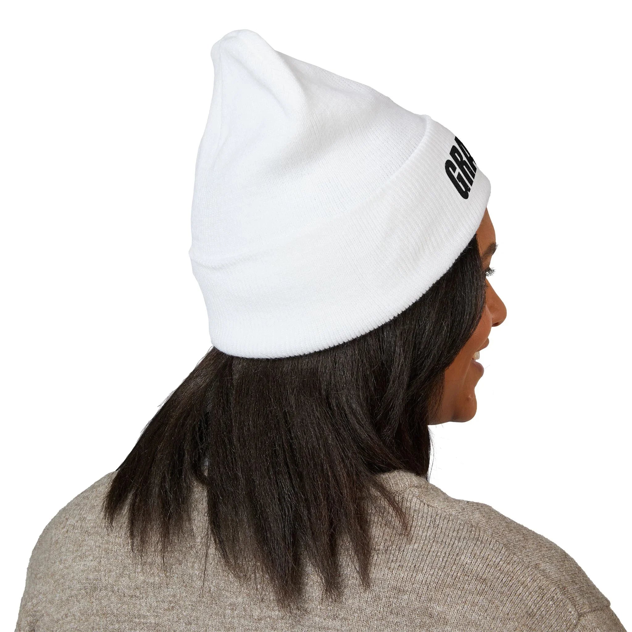 Woman wearing white protest beanie with bold text, activist apparel, statement accessory