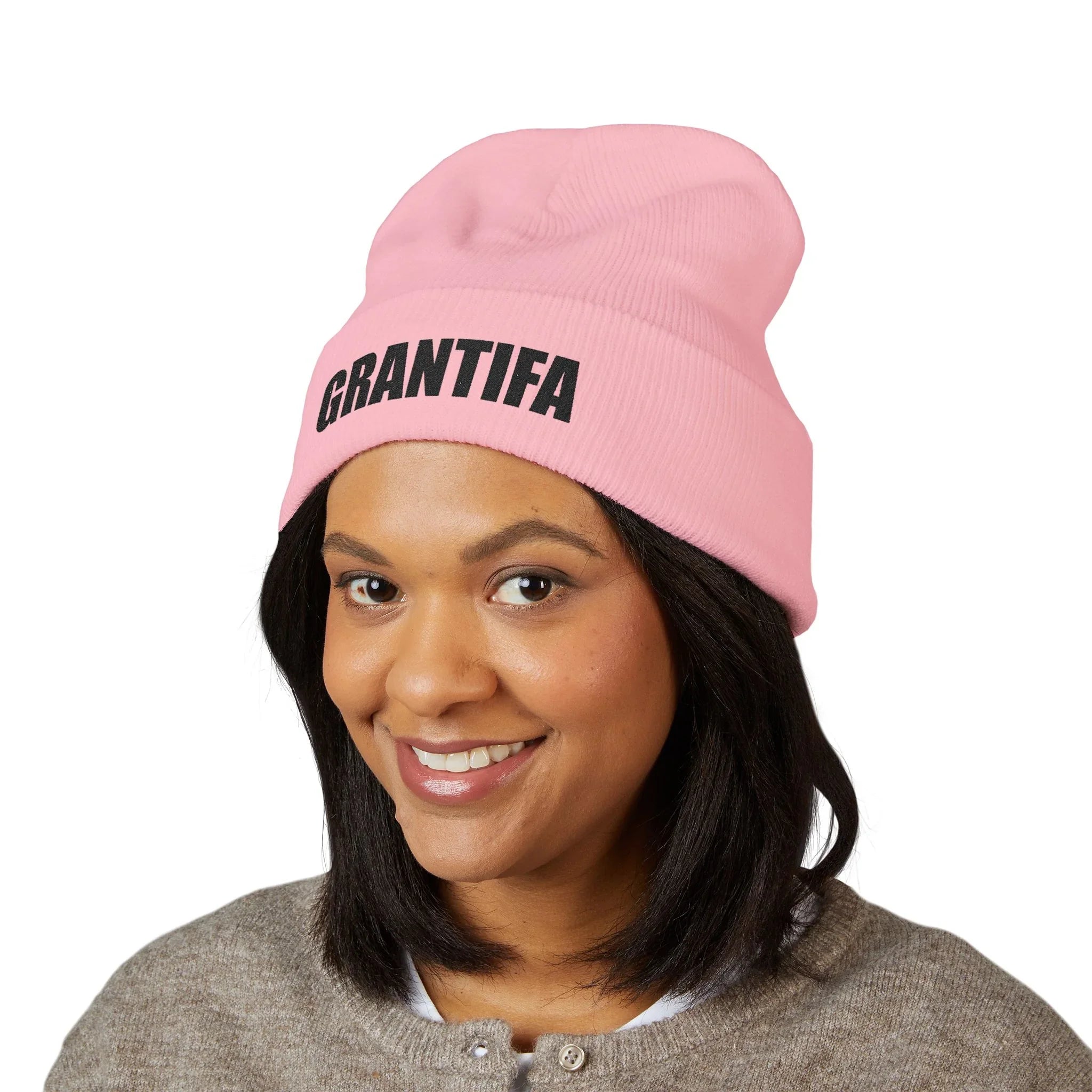 Woman wearing pink beanie with GRANTIFA graphic, statement protest hat