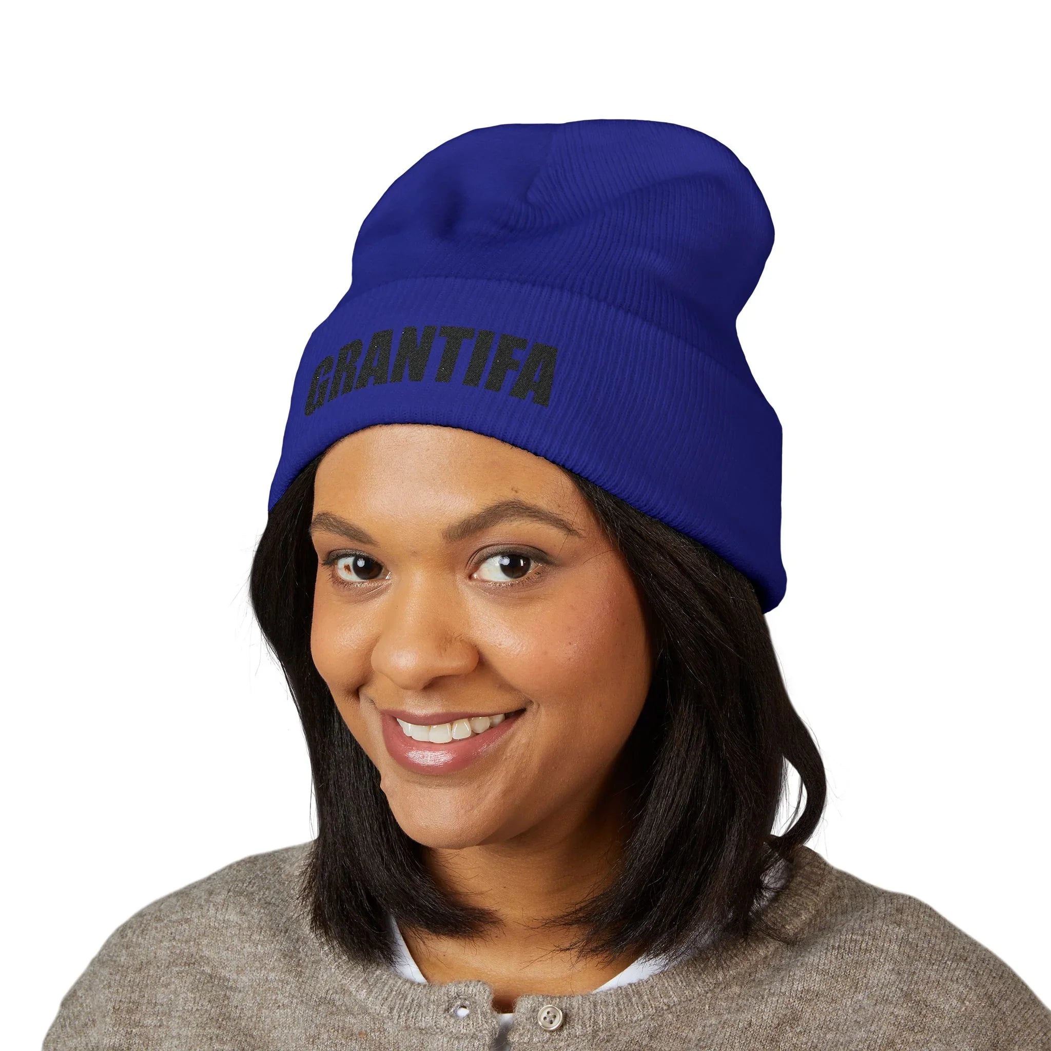 Woman wearing blue protest beanie with GRANTIFA text, activism statement winter hat
