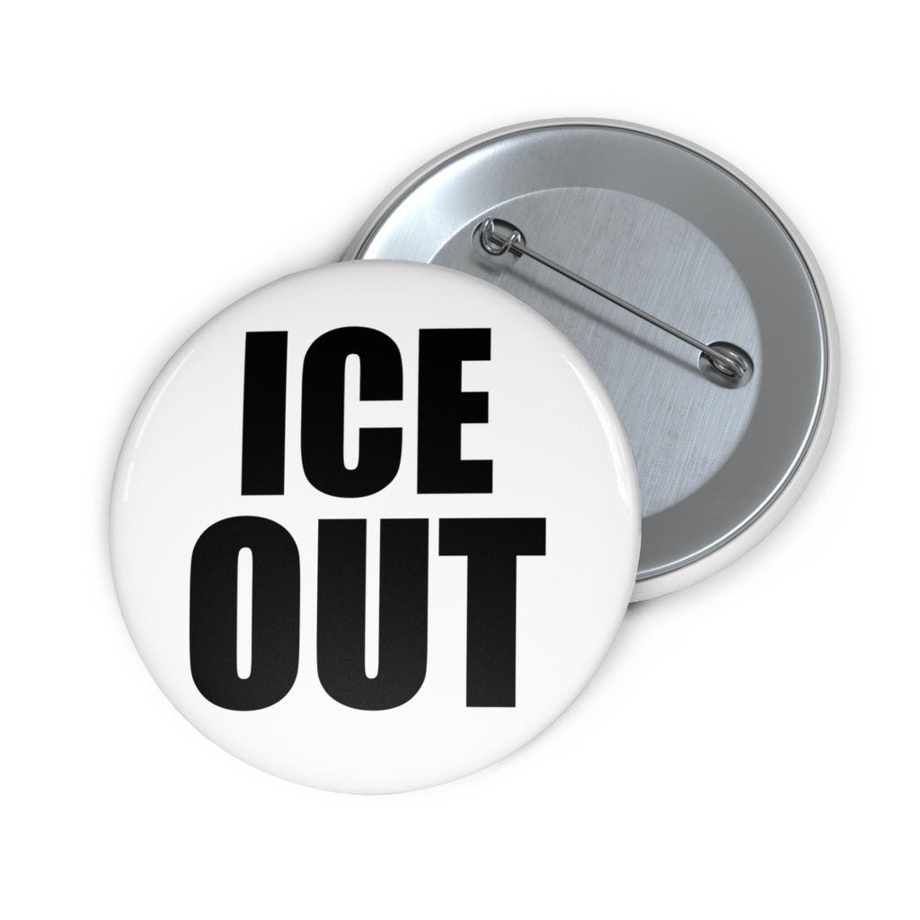 May include: A white button with the words "ICE OUT" in bold black letters. The button has a silver pin back and a shiny, reflective surface. The button is a round shape.