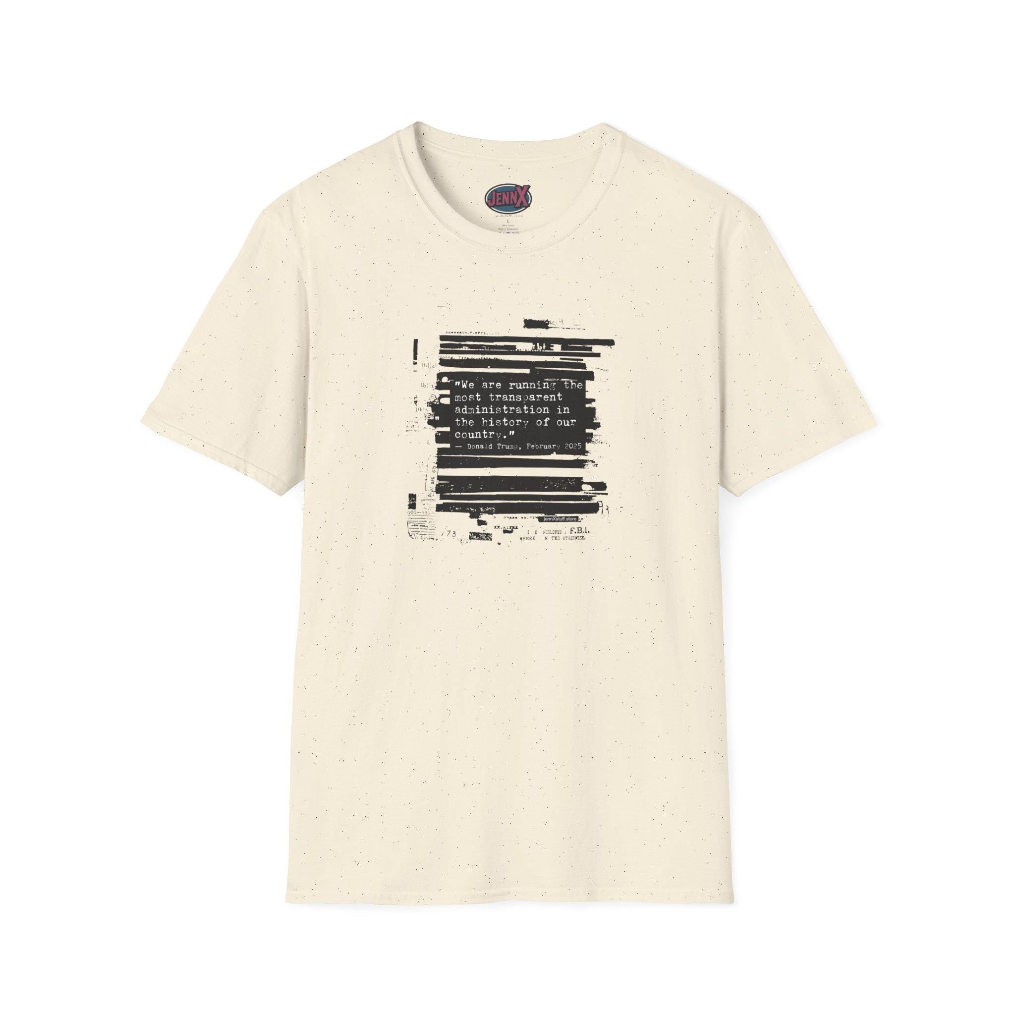 May include: Cream-colored t-shirt with a black graphic on the front. The graphic features a block of text with the words "We are running the most transparent administration in the history of our country." The shirt has a crew neck and short sleeves.