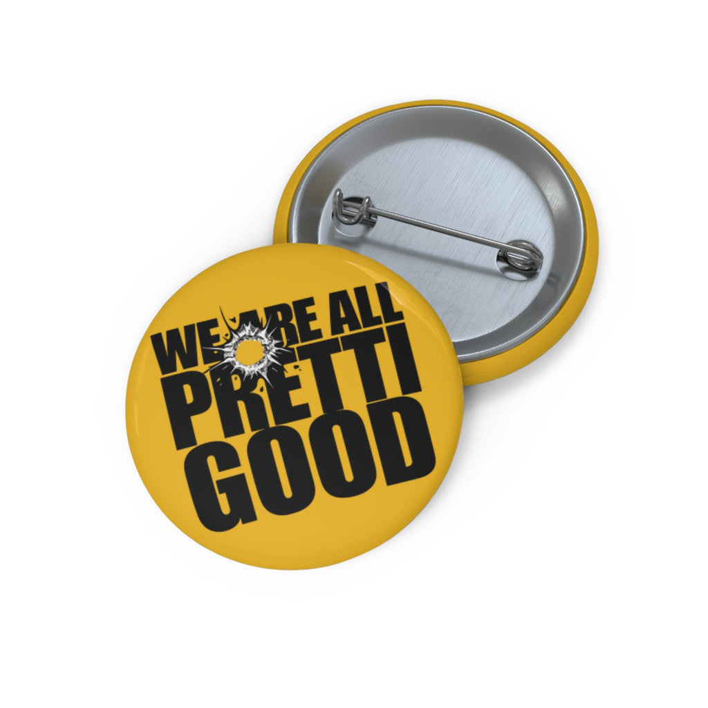 May include: Two yellow pinback buttons with the text "WE ARE ALL PRETTI GOOD" in black. One button is in focus, the other is partially visible. The buttons have a silver metal back and a safety pin closure.